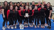 Coach Alexa Perez (far left, back row) poses with her Hunterdon Central gymnastics team after a third-place finish at the NJSIAA Team Championships.