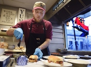Phil Maul prepares to wrap burgers at Jim's Lunch