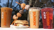 The Ben Affleck-approved DunKings menu from Dunkin', featuring (left-right): Hazelnut Heartthrob Iced Coffee, DunKings Munch Skewers, Everything Encore Breakfast Sandwich DunKings Iced Coffee and Mixed Berry Beats Dunkin’ Refresher.