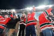 Fans in the upper deck celebrate a Devils goal during the second period the NHL Stadium Series hockey game between the New Jersey Devils and Philadelphia Flyers, outdoors, at MetLife Stadium in East Rutherford, NJ on 2/17/24.
