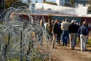 Concertina wire lines the path as members of Congress tour an area near the Texas-Mexico border, Jan. 3, 2024, in Eagle Pass, Texas. As congressional negotiators try to finalize a bipartisan deal on the border and immigration, their effort is drawing the wrath of hard-right lawmakers and former President Donald Trump. That vocal opposition threatens to unravel a delicate compromise.